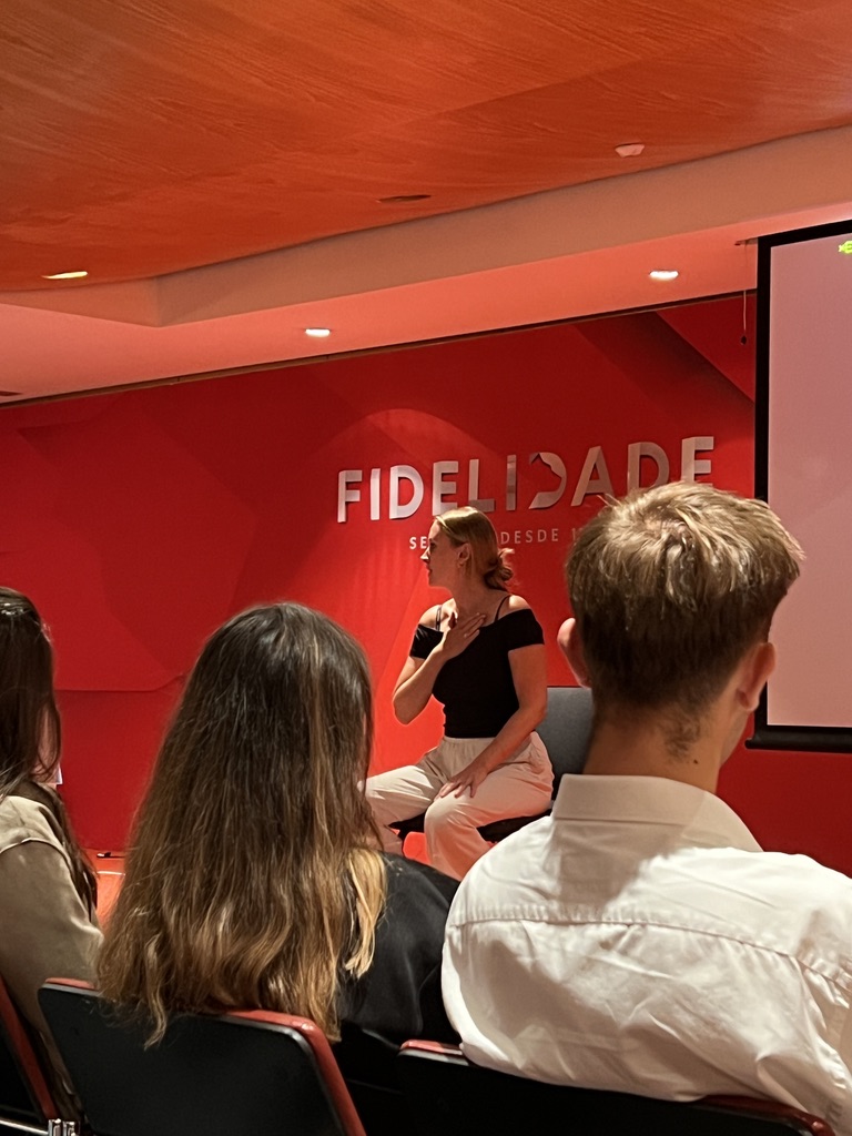 Isabel Maria demonstrating a somatic stress regulation technique at a corporate workshop