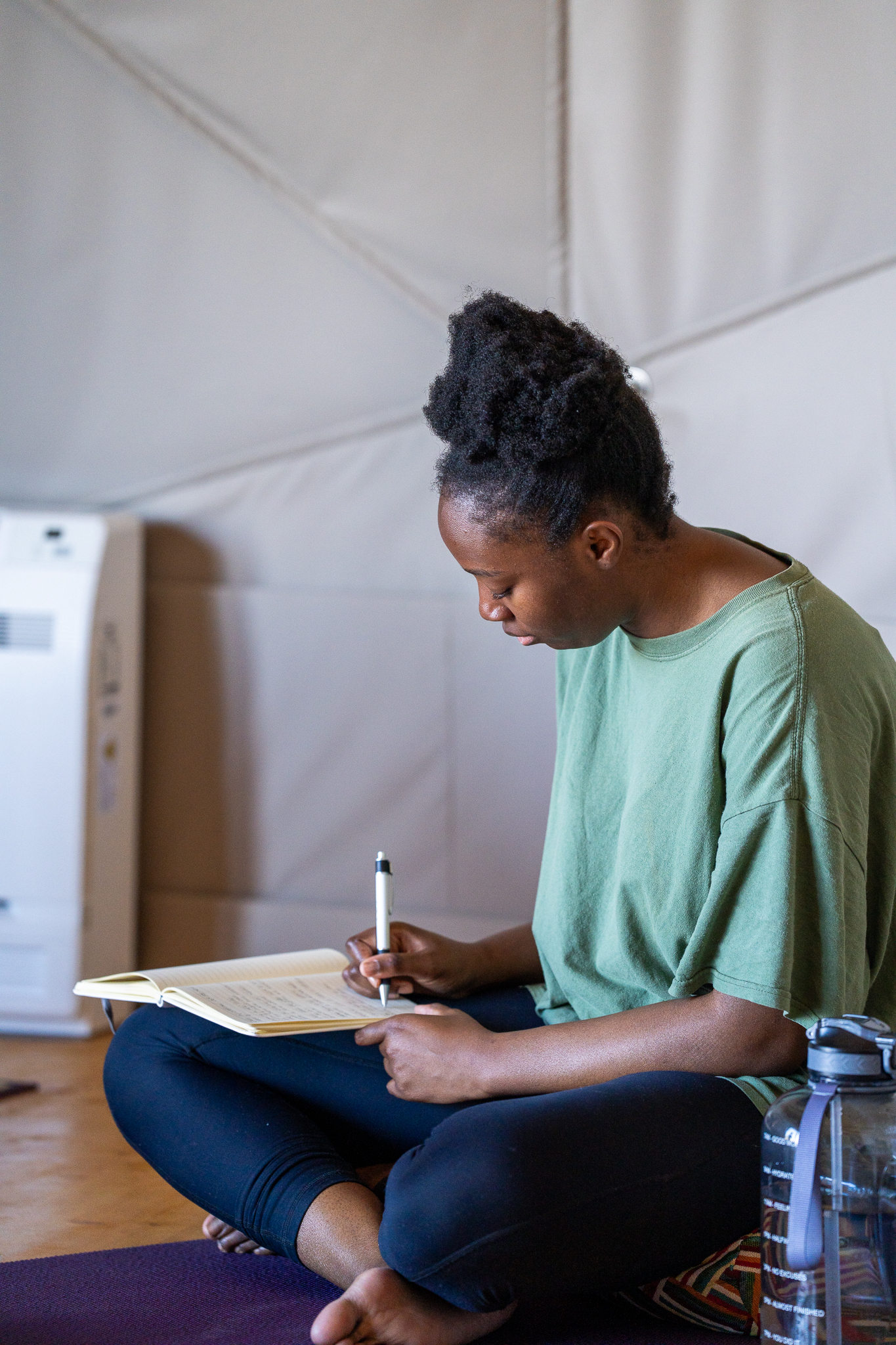 Retreat participant journaling in the dome shala, Priceless Peace